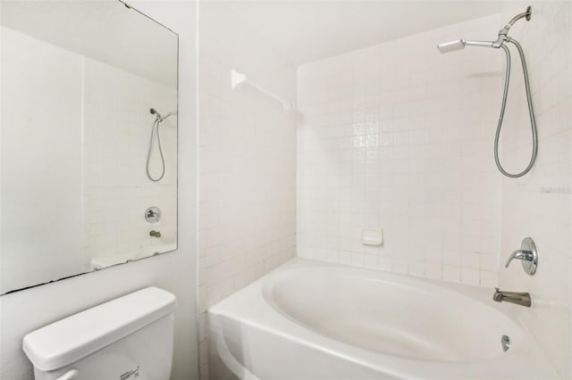 bathroom featuring tiled shower / bath and toilet