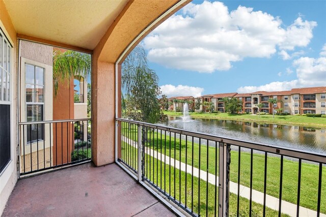 balcony featuring a water view