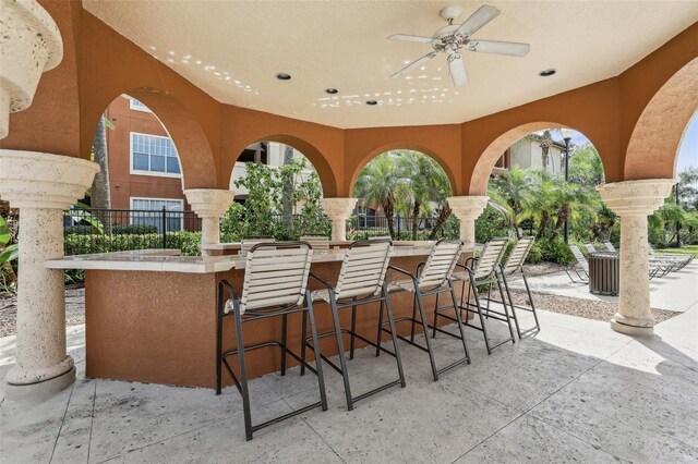 view of patio / terrace with a bar and ceiling fan