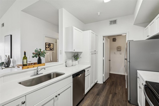 5530 Metrowest Blvd Unit 9-211, Orlando, FL 32811 - kitchen featuring appliances with stainless steel finishes, a sink, dark wood finished floors, and white cabinets