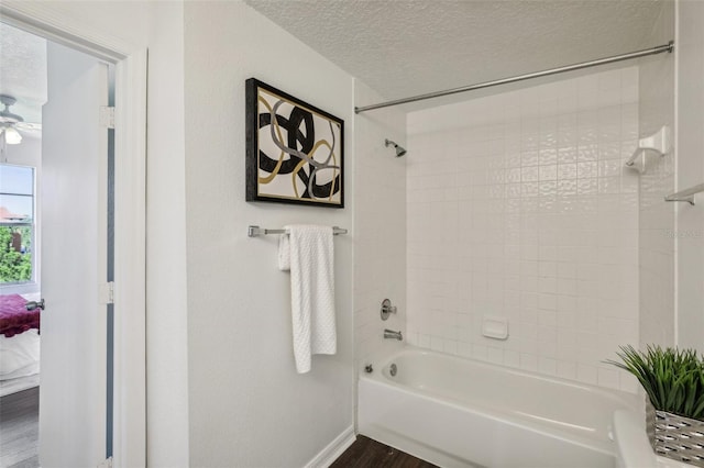 5530 Metrowest Blvd Unit 9-211, Orlando, FL 32811 - bathroom featuring  shower combination, a textured ceiling, wood finished floors, baseboards, and ensuite bathroom
