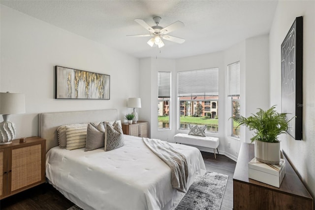 5530 Metrowest Blvd Unit 9-211, Orlando, FL 32811 - bedroom with dark wood-type flooring, ceiling fan, and baseboards