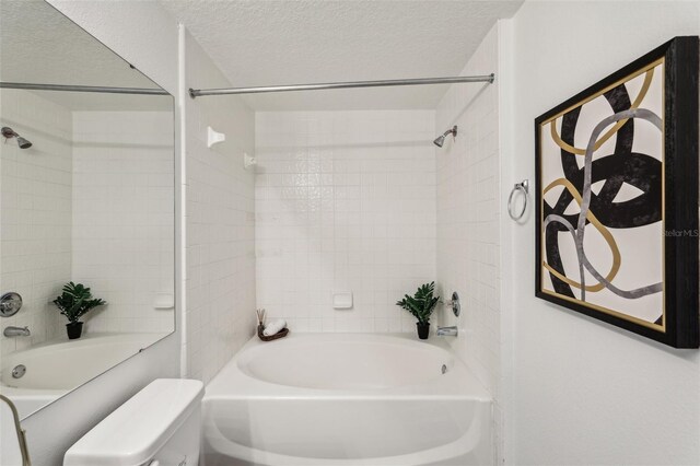 5530 Metrowest Blvd Unit 9-211, Orlando, FL 32811 - bathroom with  shower combination, a textured ceiling, and toilet