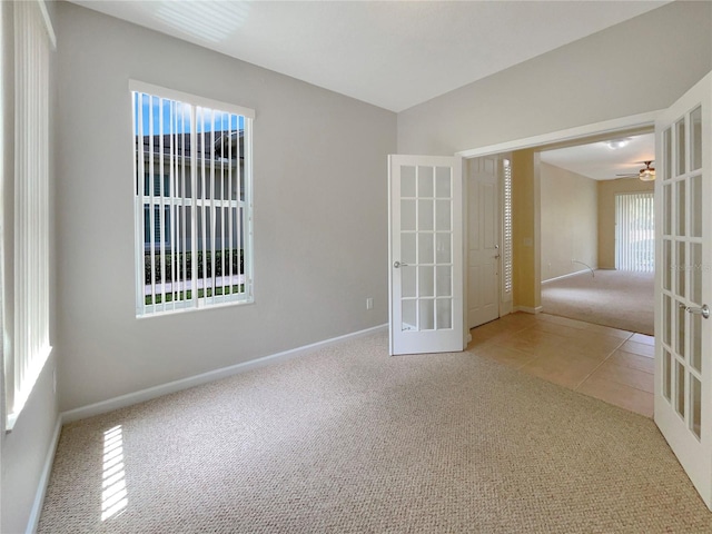 carpeted spare room with french doors and plenty of natural light