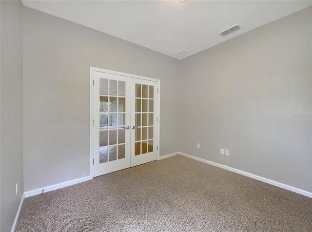 carpeted empty room featuring french doors