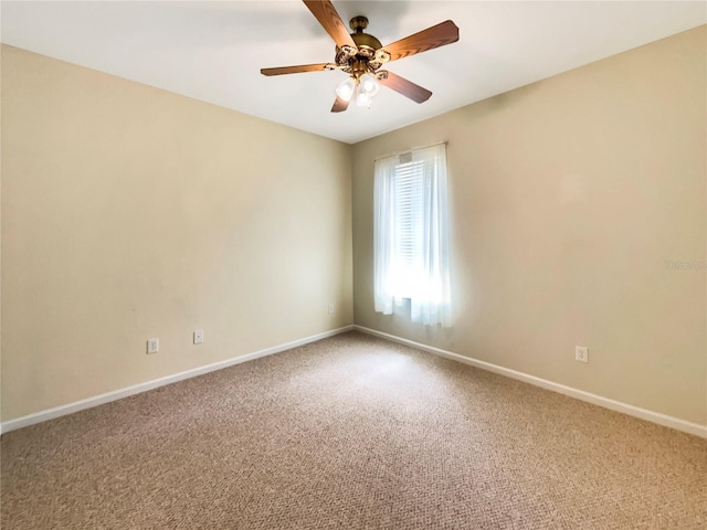 carpeted spare room featuring ceiling fan