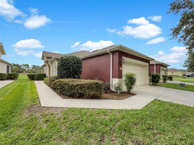 view of side of property with a garage and a yard