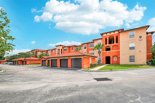 view of building exterior with community garages and a residential view