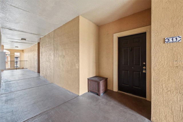 entrance to property with stucco siding