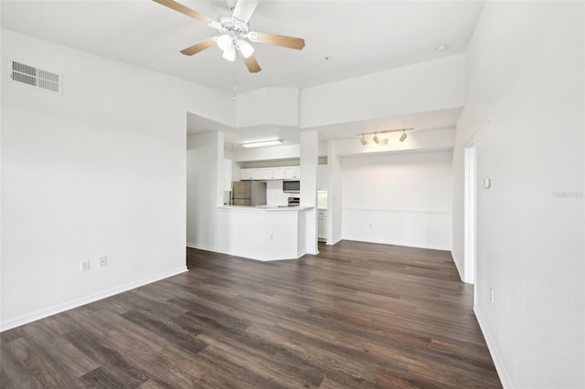 unfurnished living room featuring dark hardwood / wood-style floors and ceiling fan