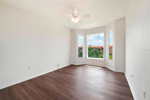 empty room with dark hardwood / wood-style floors and ceiling fan