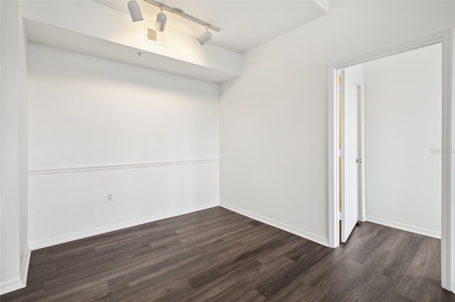 empty room with dark hardwood / wood-style flooring