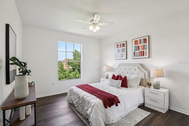 5530 Metrowest Blvd Unit 9-311, Orlando, FL 32811 - bedroom with baseboards, dark wood finished floors, a textured ceiling, and ceiling fan