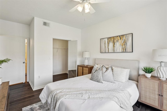 5530 Metrowest Blvd Unit 9-311, Orlando, FL 32811 - bedroom featuring wood finished floors, a closet, baseboards, ceiling fan, and a walk in closet