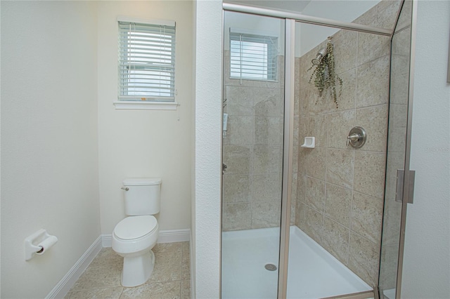 bathroom with a shower with shower door, toilet, and tile patterned flooring