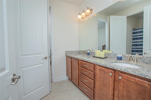 bathroom featuring tile patterned flooring and dual bowl vanity