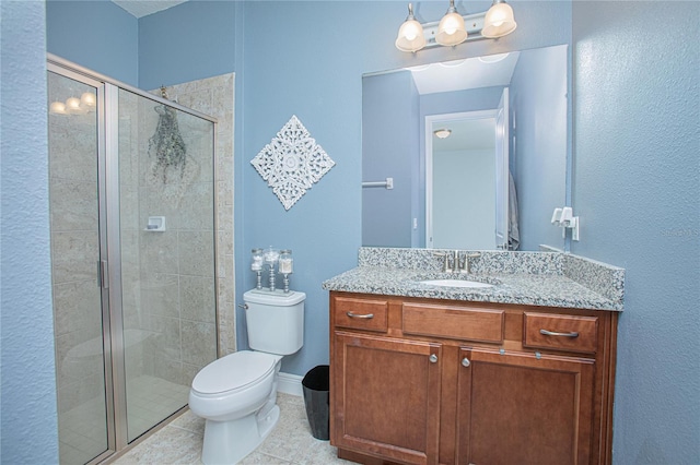 bathroom featuring tile patterned floors, vanity, an enclosed shower, and toilet