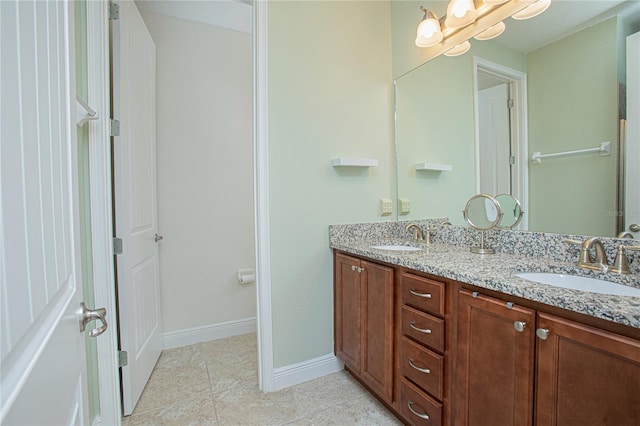 bathroom with double vanity and tile patterned floors