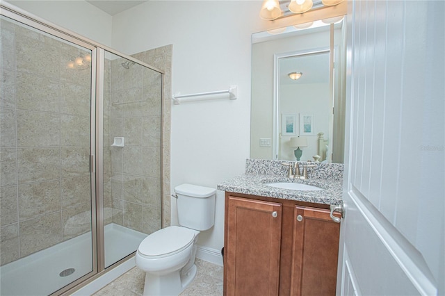 bathroom with a shower with shower door, vanity, tile patterned flooring, and toilet