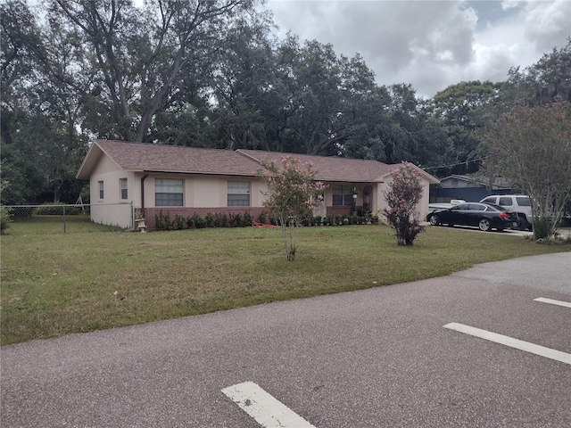 single story home featuring a front lawn