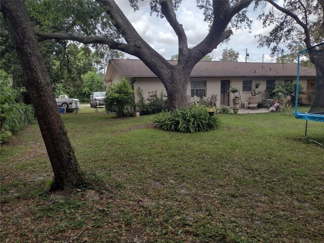 view of yard featuring a trampoline