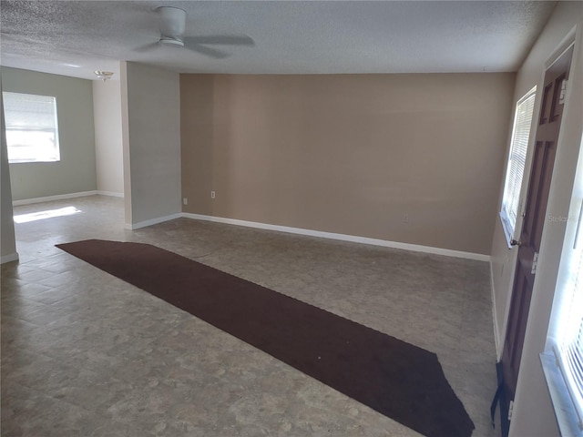 spare room with ceiling fan and a textured ceiling