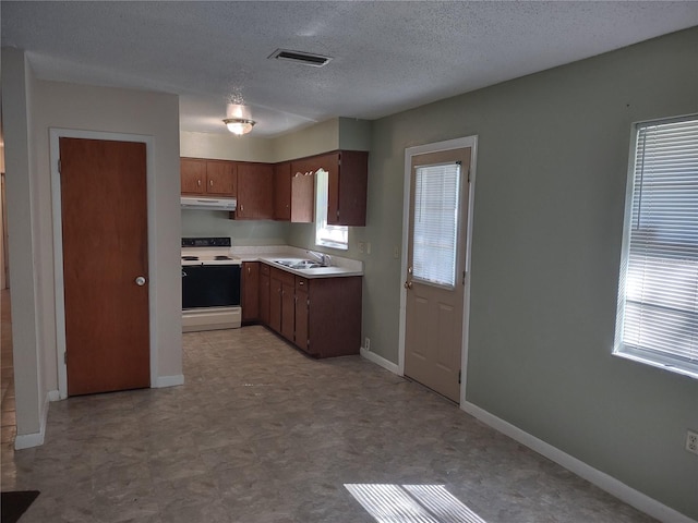 kitchen featuring white electric range, sink, and a textured ceiling