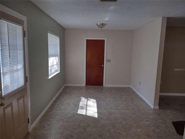 empty room with a textured ceiling