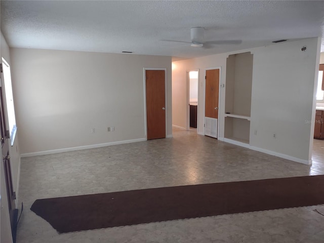 spare room with ceiling fan and a textured ceiling