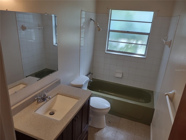 full bathroom with vanity, toilet, tiled shower / bath combo, and tile patterned flooring