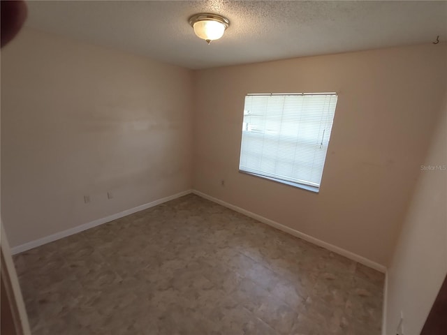 empty room featuring a textured ceiling