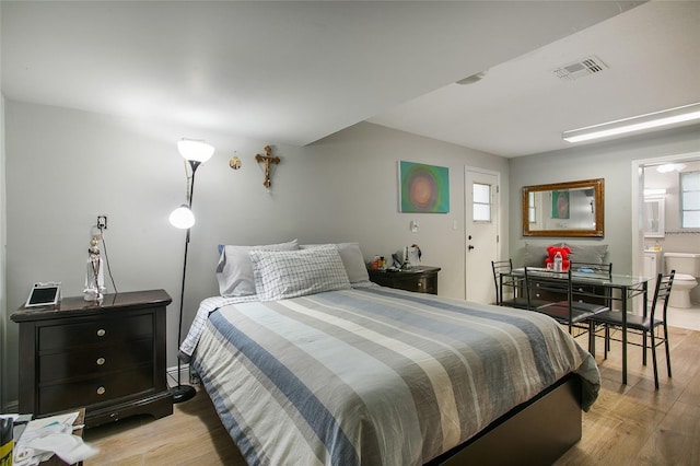 bedroom with light wood-type flooring, visible vents, and multiple windows