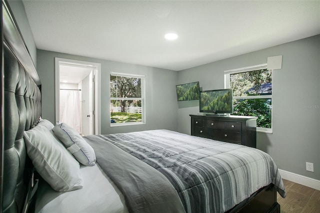 bedroom with wood finished floors and baseboards