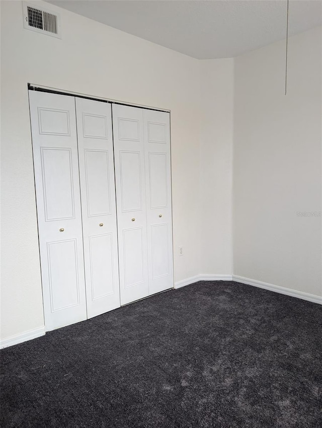 unfurnished bedroom featuring a closet and carpet