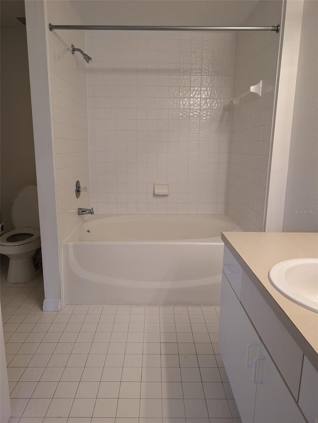 full bathroom with tiled shower / bath, vanity, and toilet