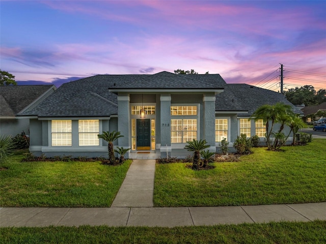 view of front of property with a lawn