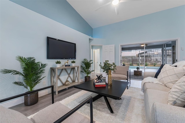 living room with high vaulted ceiling, hardwood / wood-style flooring, and ceiling fan