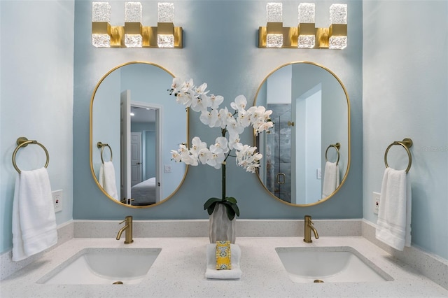 bathroom with vanity and a shower with door