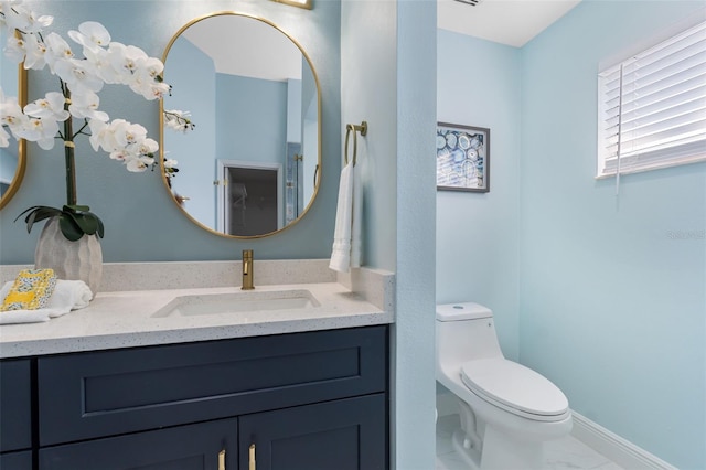 bathroom featuring vanity and toilet