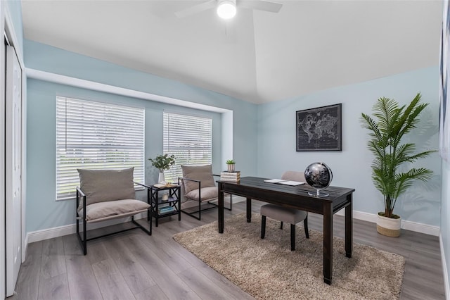 office area featuring light hardwood / wood-style floors, vaulted ceiling, and ceiling fan