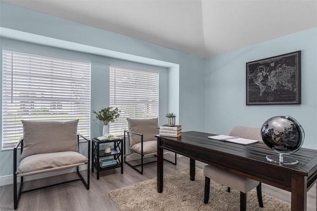 office area with vaulted ceiling and light hardwood / wood-style floors