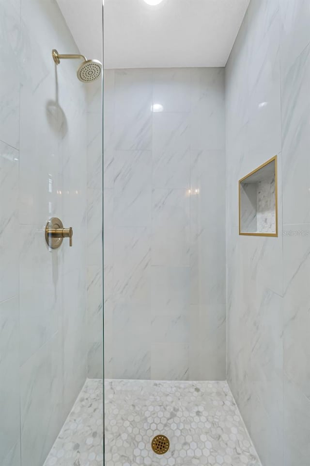 bathroom with tiled shower