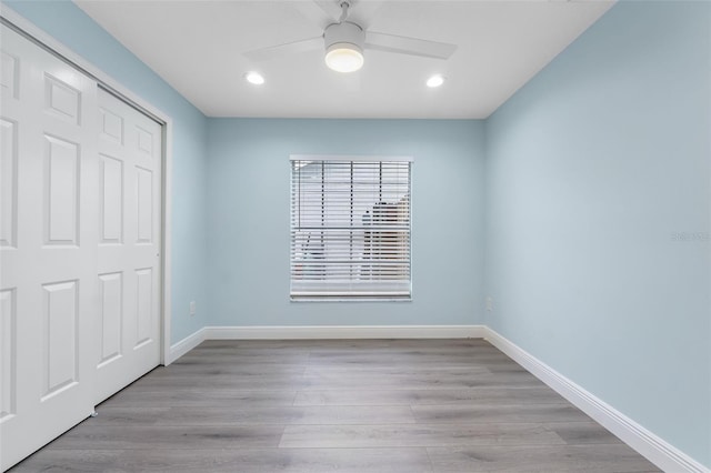 unfurnished bedroom with light wood-type flooring, a closet, and ceiling fan