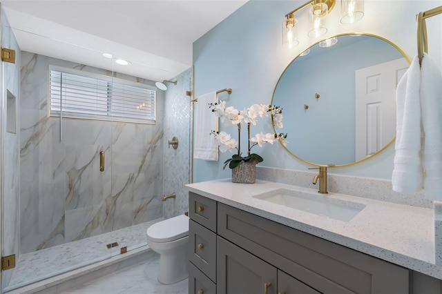 bathroom featuring toilet, vanity, and walk in shower