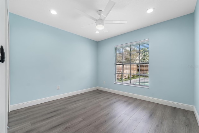 empty room with ceiling fan and wood-type flooring