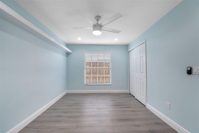 unfurnished bedroom with ceiling fan, a closet, and light hardwood / wood-style floors