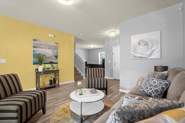 living room featuring hardwood / wood-style floors and a textured ceiling