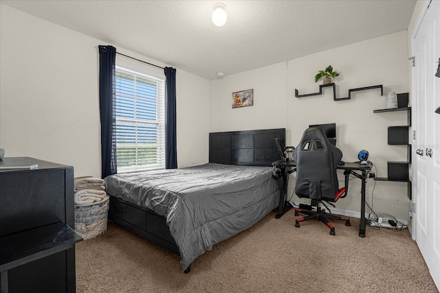 carpeted bedroom with a textured ceiling and baseboards