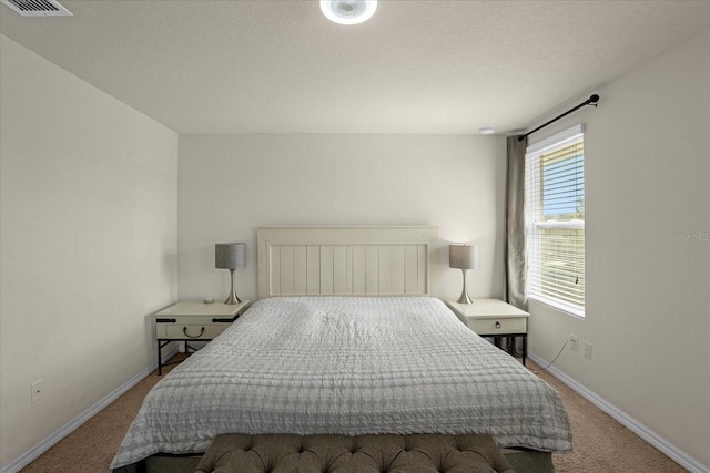 bedroom featuring carpet, visible vents, and baseboards