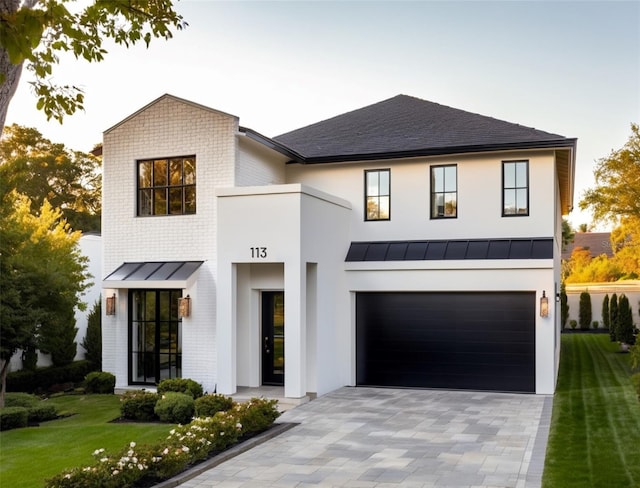 view of front of property with a lawn and a garage